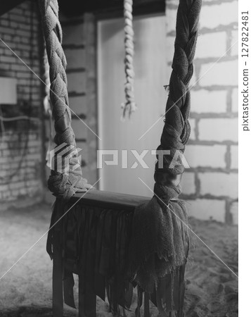 This artwork highlights a rope and wooden structure set within a rustic, serene environment, 127822481