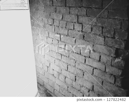 A beautifully textured brick wall illuminated with soft and gentle light creates a warm ambiance A beautifully textured brick wall illuminated with soft and gentle light creates a warm ambiance 127822482