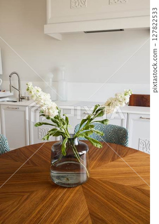 An Elegant Floral Arrangement Displayed Beautifully on a Modern Wooden Table Setting An Elegant Floral Arrangement Displayed Beautifully on a Modern Wooden Table Setting 127822533