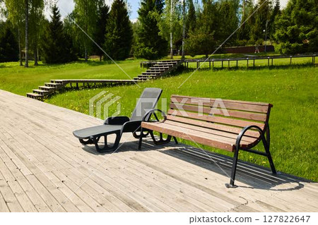 Enjoying a Peaceful and Relaxing Experience with Comfortable Outdoor Seating in a Lush Green Park 127822647