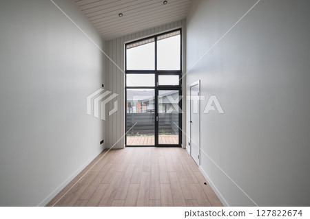 The design features modern minimalist interiors with large windows for natural light and warmth 127822674