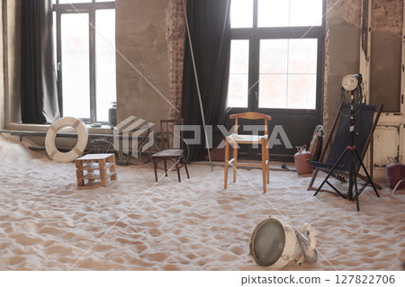An Artistic Space Featuring Chairs on a Sandy Floor with inspiring Minimalist Design Elements 127822706