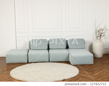 A Modern Stylish Sofa in a Light Blue Color with a Contemporary and Elegant Design Style A Modern Stylish Sofa in a Light Blue Color with a Contemporary and Elegant Design Style 127822722