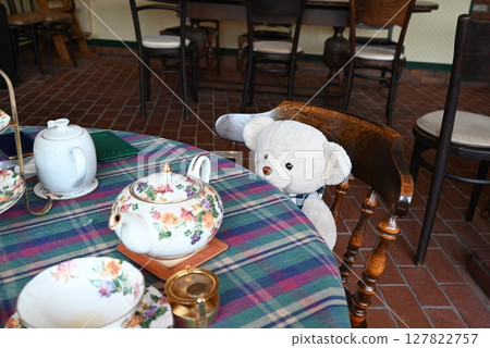 Teddy bear having tea in a British cafe 127822757