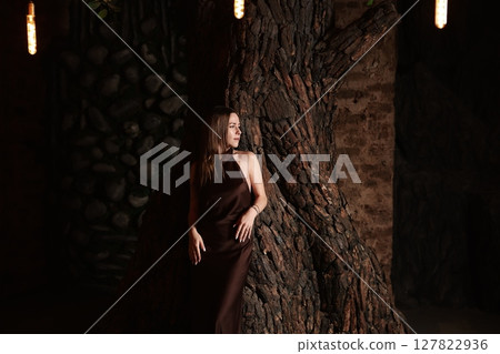 An Elegant Model Posing Gracefully Against a Beautiful Rustic Background in Natures Glow 127822936