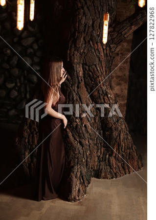 An Ethereal Figure Draped in Earthy Textures Situated within a Captivating Mystical Setting An Ethereal Figure Draped in Earthy Textures Situated within a Captivating Mystical Setting 127822968