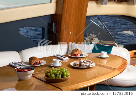 An Elegant Breakfast Setup on a Beautiful, Luxury Yacht with Stunning Amenities and Views An Elegant Breakfast Setup on a Beautiful, Luxury Yacht with Stunning Amenities and Views 127823016
