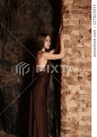 Ethereal and Artistic Pose in a Mysterious Dark Cave Captivating Fashion Photography Ethereal and Artistic Pose in a Mysterious Dark Cave Captivating Fashion Photography 127823033