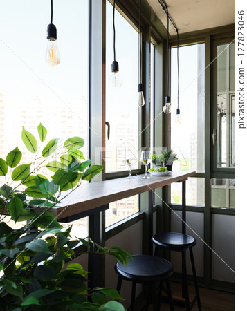 A Chic Modern Balcony with Stunning Greenery and Natural Light for Comfort and Style 127823046