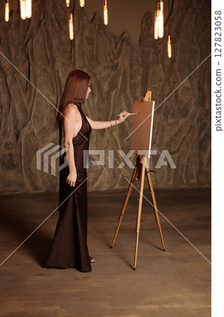 The Artistic Process of a Female Artist Dressed in Elegant and Chic Attire During Creation 127823058