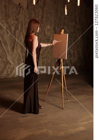 An Elegant Artist Engaged in Creative Work Within a Timeless and Inspiring Studio Setting 127823060