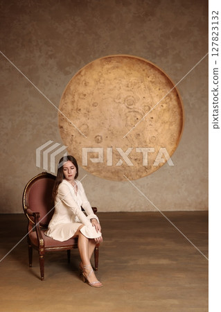 Enchanting Fantasy Portrait Featuring a Captivating Moon Motif and a Stylish Vintage Chair Enchanting Fantasy Portrait Featuring a Captivating Moon Motif and a Stylish Vintage Chair 127823132