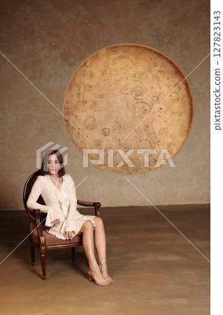 An Elegant Woman Posing Gracefully with an Artistic Moon Backdrop in a Beautiful Setting 127823143