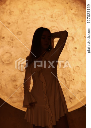 Silhouette Artistically Captured in Motion Against a Beautiful Lunar Backdrop at Night Silhouette Artistically Captured in Motion Against a Beautiful Lunar Backdrop at Night 127823169