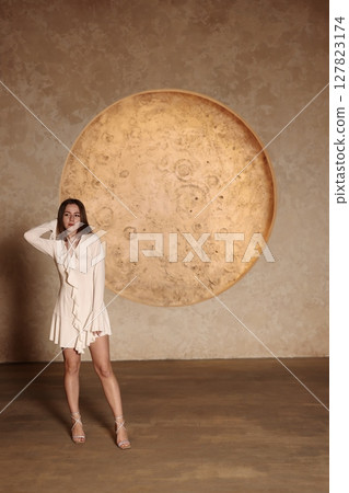 An Elegant Woman Gracefully Posing Against an Artistic and Dreamy Moonlit Background 127823174