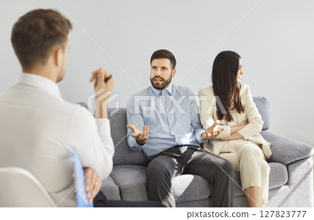 Psychologist Counseling Quarreling Couple During Therapy Session Psychologist Counseling Quarreling Couple During Therapy Session 127823777