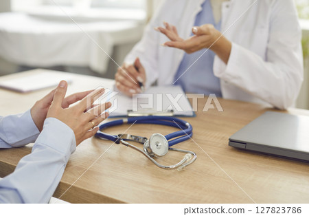 Close-Up Of Stethoscope On Table During Medical Consultation In Hospital Office Close-Up Of Stethoscope On Table During Medical Consultation In Hospital Office 127823786