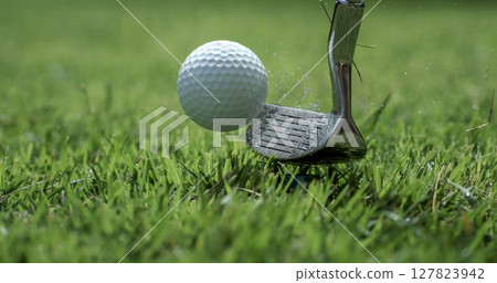 Golf club hits a golf ball. 127823942