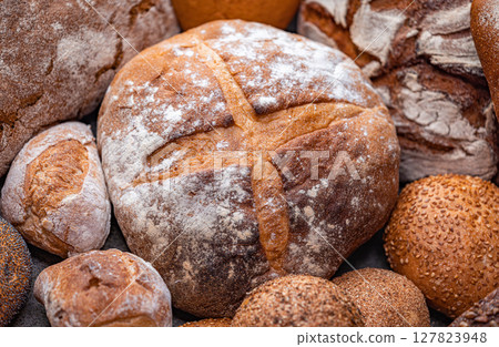Freshly baked natural bread is on the kitchen table. Freshly baked natural bread is on the kitchen table. 127823948