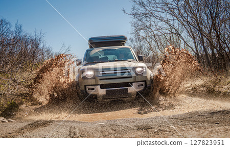 Off road tourist car rides off-road in the highlands. 127823951