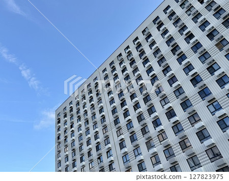 Apartment building on the background of blue sky, new building. High quality photo 127823975
