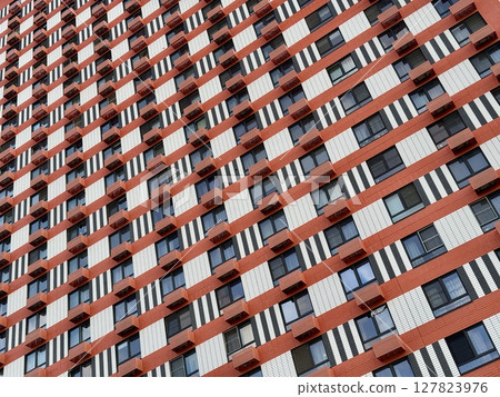 Apartment building on the background of blue sky, new building. High quality photo 127823976