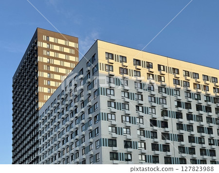 Apartment building on the background of blue sky, new building. High quality photo 127823988