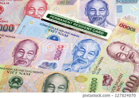 American permanent resident card on Vietnamese dong 127824070