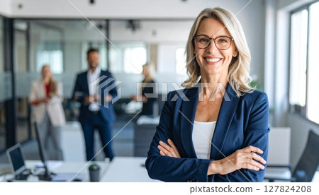Confident smiling woman with office background 127824208