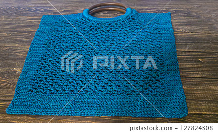 Knitting a product from a cord with a crochet hook. Step-by-step instructions 127824308