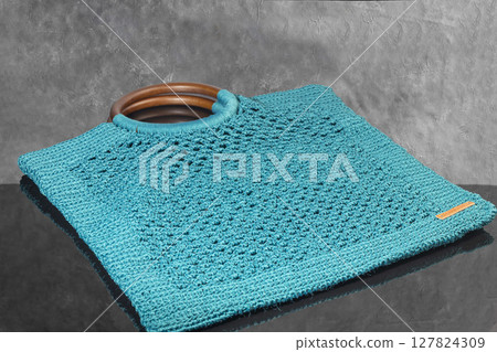 Knitting a product from a cord with a crochet hook. Step-by-step instructions 127824309