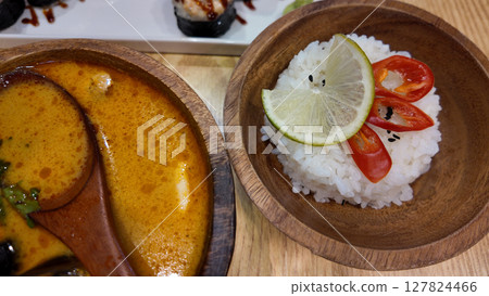 Tom yum with rice in a wooden bowl 127824466