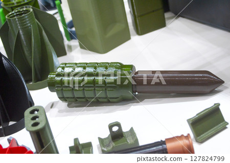 Model of an anti-personnel trip mine printed on 3D printer from melted plastic. Mine created on 3D printer. Prototype ammunition printed on 3D printer. Innovation 3d printing. Innovation technology Model of an anti-personnel trip mine printed on 3D printer from melted plastic. Mine created on 3D printer. Prototype ammunition printed on 3D printer. Innovation 3d printing. Innovation technology 127824799