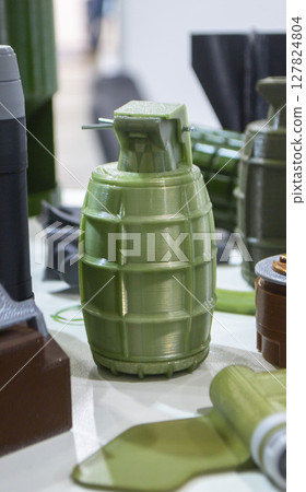 Grenade body printed on 3D printer from melted plastic. Plastic grenade created on 3D printer. Prototype of ammunition printed on 3D printer. Innovation 3d printing. Innovation printing technology 127824804