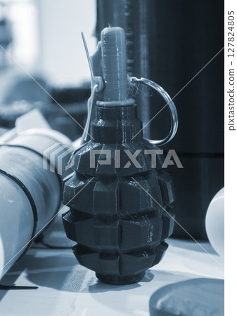 Grenade body printed on 3D printer from melted plastic. Plastic grenade created on 3D printer. Prototype of ammunition printed on 3D printer. Innovation 3d printing. Innovation printing technology 127824805