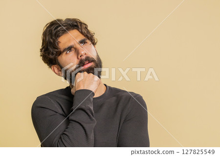 Bored young man exhausted of tedious story, not interested in communication on beige background Bored young man exhausted of tedious story, not interested in communication on beige background 127825549