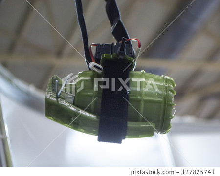 Hanging grenade. Grenade printed on 3D printer from melted plastic. Plastic grenade created on 3D printer. Prototype of ammunition printed on 3D printer. Innovation 3d printing. Innovation technology Hanging grenade. Grenade printed on 3D printer from melted plastic. Plastic grenade created on 3D printer. Prototype of ammunition printed on 3D printer. Innovation 3d printing. Innovation technology 127825741