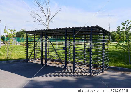 A modern outdoor shelter for efficient bike storage and equipment, ensuring safety for users 127826336
