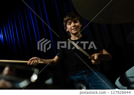 A boy plays drums in a recording studio 127826644