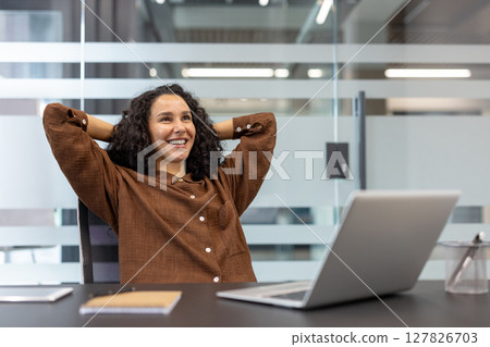 Successful businesswoman well done, successfully completed current project. Office worker with hands behind head resting and relaxing, enjoying results of achievement. 127826703