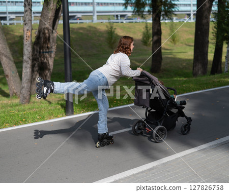 Caucasian woman roller skating with her toddler son in a stroller.  127826758