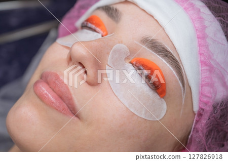 Caucasian woman undergoing eyelash lamination procedure.  127826918