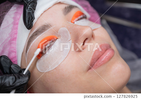 Caucasian woman undergoing eyelash lamination procedure. Caucasian woman undergoing eyelash lamination procedure. 127826925