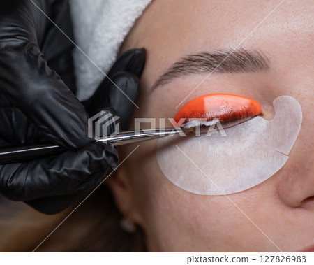 Caucasian woman undergoing eyelash lamination procedure.  127826983