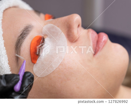 Caucasian woman undergoing eyelash lamination procedure. Caucasian woman undergoing eyelash lamination procedure. 127826992