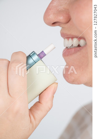 Caucasian woman smoking electronic cigarette. Tobacco heating system. Caucasian woman smoking electronic cigarette. Tobacco heating system. 127827043