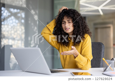 Upset and disappointed woman got error and laptop crash, unsatisfied woman looking at laptop screen. Office worker inside office at workplace. Upset and disappointed woman got error and laptop crash, unsatisfied woman looking at laptop screen. Office worker inside office at workplace. 127828024