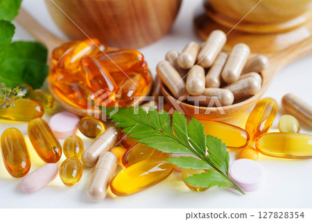 Alternative medicine herbal organic capsule with vitamin E omega 3 fish oil, mineral, drug with herbs leaf natural supplements for healthy good life. Alternative medicine herbal organic capsule with vitamin E omega 3 fish oil, mineral, drug with herbs leaf natural supplements for healthy good life. 127828354