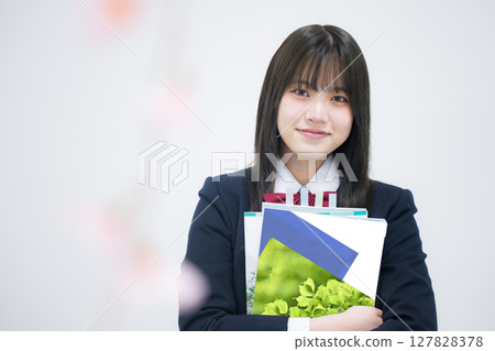 A high school girl holding a textbook for university entrance exams at cram schools and prep schools 127828378