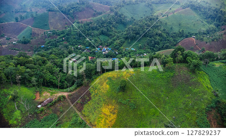 Rainy season landscape of a mountain village in the morning and mountains in the background. 127829237